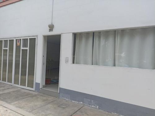 a white building with sliding glass doors on it at Monterrico Suites Hotel in Lima