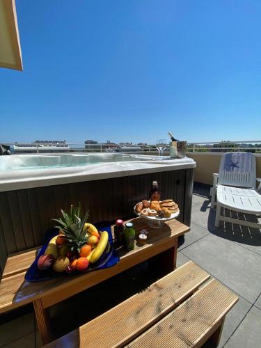 a tray of fruit on a table on a balcony at Hotel Maioli B&B in Misano Adriatico