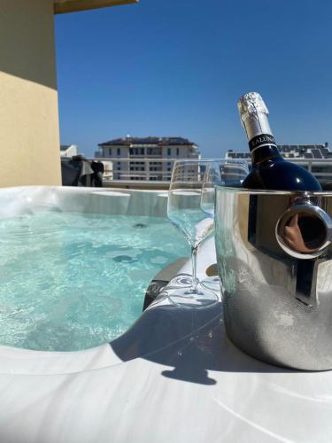 a bottle of wine and a wine glass on a table at Hotel Maioli B&B in Misano Adriatico