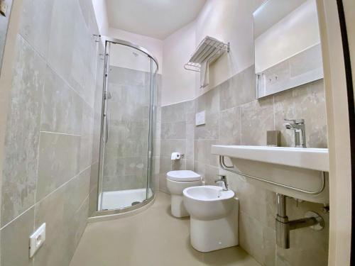 a bathroom with a toilet and a sink and a shower at Hotel Maioli B&B in Misano Adriatico