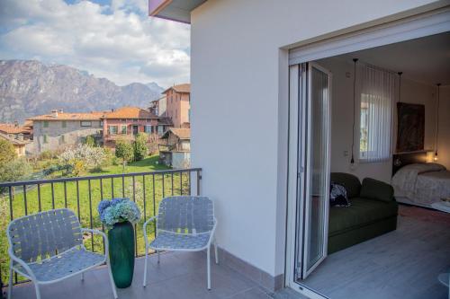 a balcony with two chairs and a couch on a balcony at Domus Bellagio in Bellagio