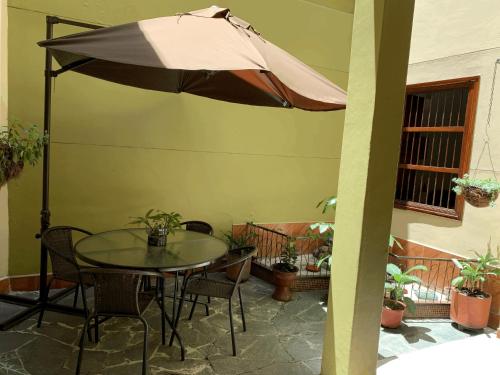 a patio with a table and an umbrella at Casa Grande in Medellín