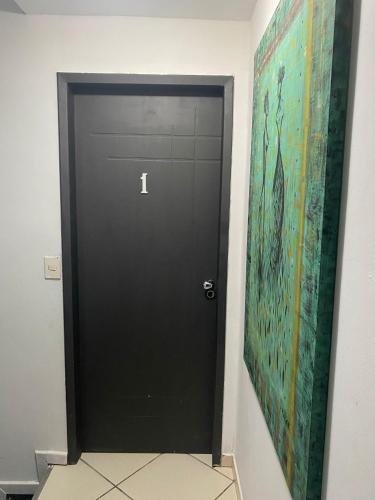 a black door in a room with a painting at Ipanema Club Hostel in Rio de Janeiro