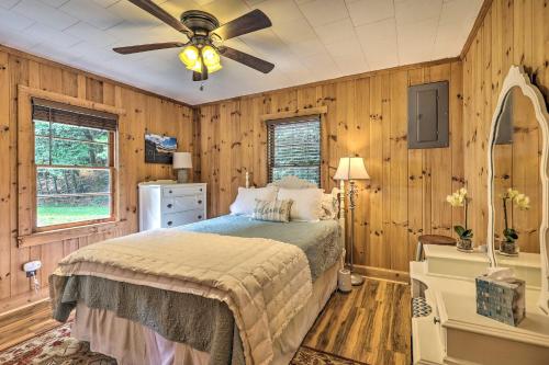 een slaapkamer met een bed en een plafondventilator bij Peaceful Roaring Gap Retreat with Fire Pit and Patio! in Roaring Gap