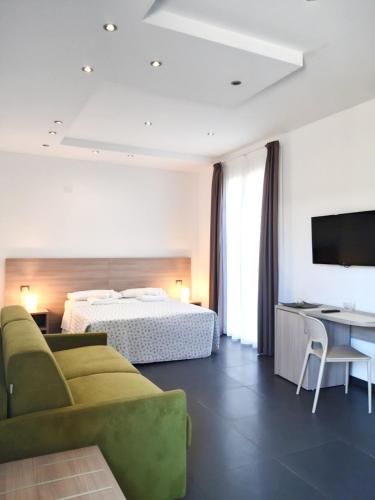 a hotel room with a bed and a couch and a table at RipamontiBnB in Milan