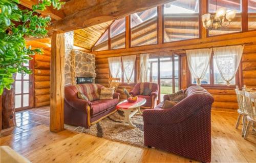 a living room with two couches and a table at Wooden House Sveti Rok in Sveti Rok