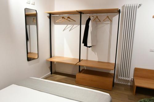 a dressing room with a shelf and a mirror at Nu House Rooms & Apartments in Cassano delle Murge