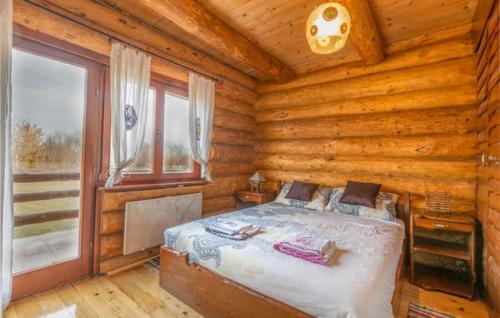 a bedroom with a bed in a log cabin at Wooden House Sveti Rok in Sveti Rok