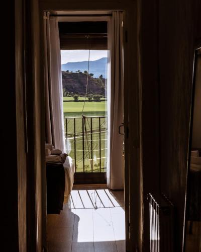 a room with a door open to a balcony with a view at Casa Tato Figuerola d'Orcau in Figuerola de Orcau