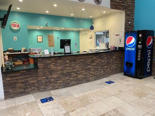 a pepsi machine in front of a counter in a store at B&J HOTEL AND APARTMENTS in Pecos