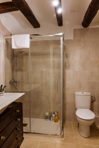 a bathroom with a toilet and a glass shower at Casa Tato Figuerola d'Orcau in Figuerola de Orcau