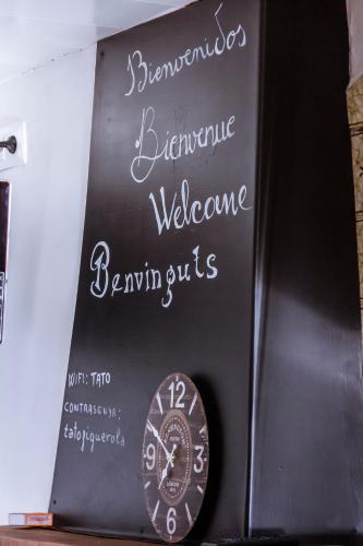 a chalkboard with a clock on a wall at Casa Tato Figuerola d'Orcau in Figuerola de Orcau