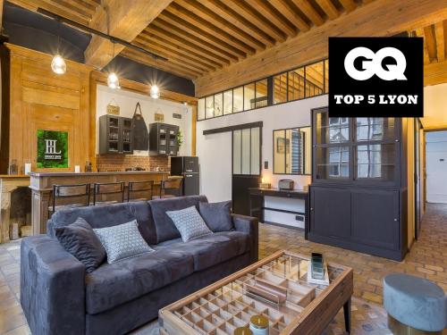 a living room with a couch and a kitchen at HOST INN - CŒUR VIEUX LYON & SPA in Lyon