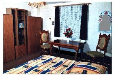 a bedroom with a bed and a table and chairs at Bramkamp Pension in Dallgow