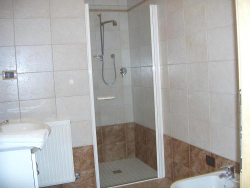 y baño con ducha y lavamanos. en Ferienwohnung im Haus Texel IV, en Rablà