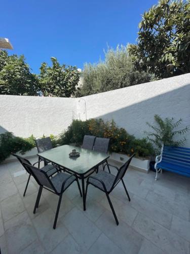 a table and chairs sitting on a patio at Marena 1 in Makry Gialos