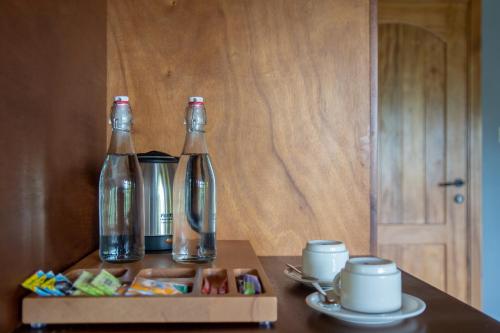 a table with two bottles and a box of candy at Chimpundu Lodge in Fort Portal