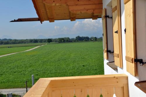 a view of a large green field from a porch at Springerhof in Schechen