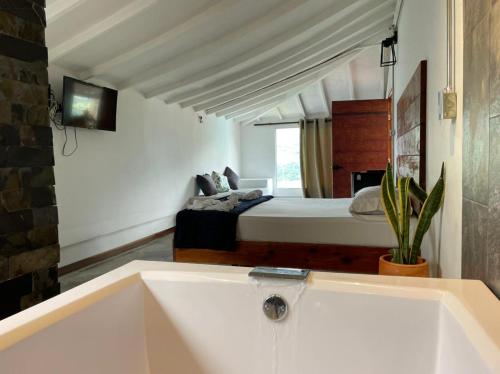 a bath tub in a room with a bed at All Natural Glamping in Copacabana