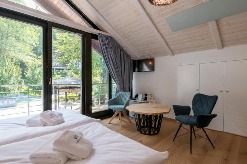 a bedroom with two beds and a table and chairs at Resort CATTALEYA in Čeladná