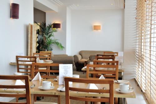 a row of tables and chairs in a restaurant at Carousel Hotel in Blackpool