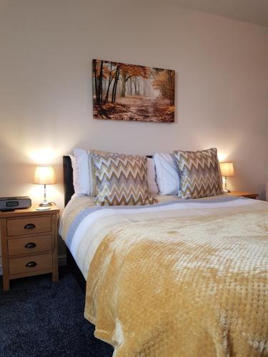 a bedroom with a bed and a table with a lamp at Park View Chase in York