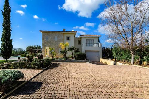 a brick driveway in front of a house at Villa Kiki in Peyia