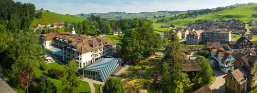 an aerial view of a small town with houses and trees at Resort Hof Weissbad in Weissbad