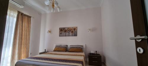 a bedroom with a bed in a room with a window at Munxar Holiday Apartment in Marsaskala