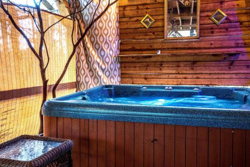 a jacuzzi tub in the corner of a house at The TreeHouse - Rocking Chair Deck with Hot Tub below, Walking Distance to Downtown Helen, Sleeps 5 in Helen