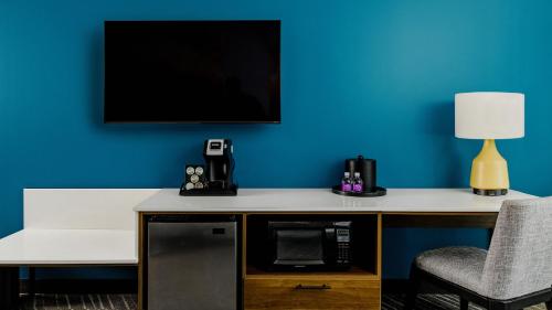 a room with a desk with a tv and a chair at Lucky Star Casino Hotel & Convention Center in Watonga