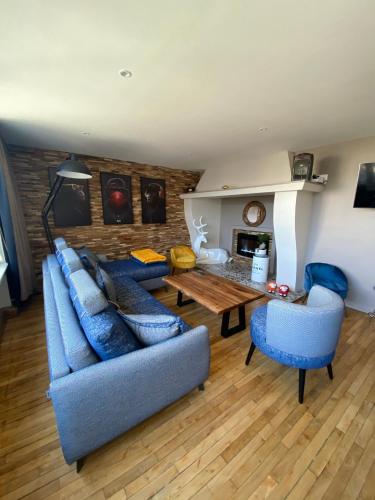 a living room with blue couches and a table at Bliss’appart boulogne/mer logement avec balnéothérapie in Boulogne-sur-Mer