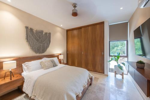 Una cama o camas en una habitación de BIT Tulum Villas