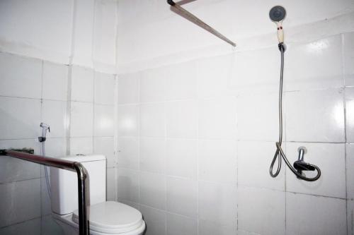 a bathroom with a toilet and a shower at Charisma Residence Syariah in Surabaya
