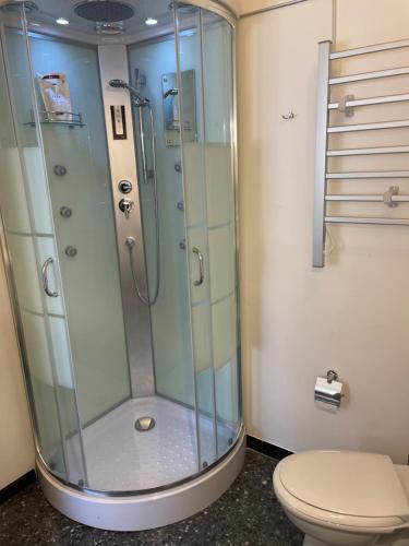 a glass shower in a bathroom with a toilet at Il giardino di Iole Via Giovanni Amendola n36 in Sassari