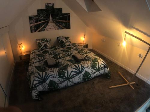 a bedroom with a bed in a attic at La Maison du Moulin à Vent in La ForestiÃ¨re
