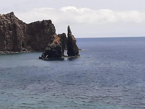 a rock formation in the middle of the ocean at MI CUMANESA in Frontera