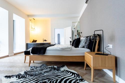 a bedroom with a bed with a zebra print rug at La Bouche Appartements in Oświęcim