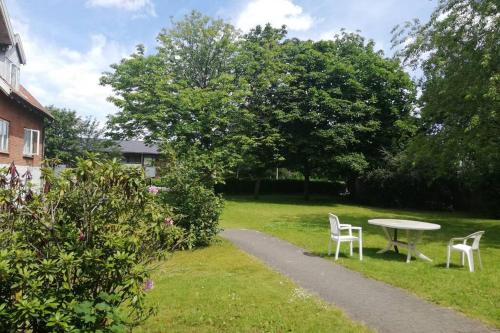 a table and two chairs and a table in a yard at 300 meter walk to Lego house - Door 9 in Billund