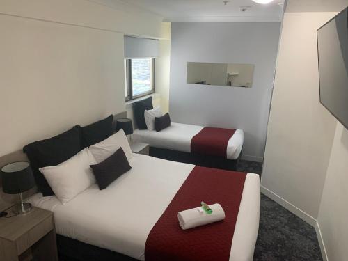 a hotel room with two beds at George Williams Hotel in Brisbane