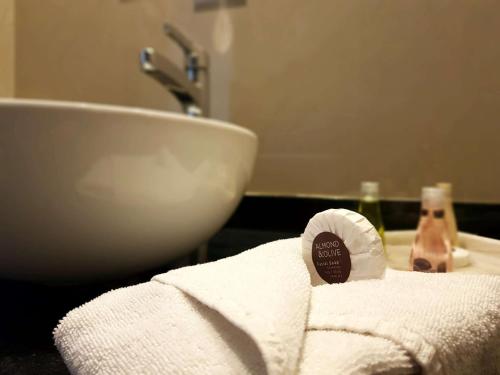 a bathroom with a white towel and a sink at Best Western Plus Metepec & Suites in Toluca