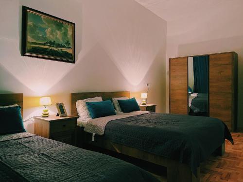 a bedroom with two beds and a mirror at Le Royal Suites Sarajevo - City Center in Sarajevo