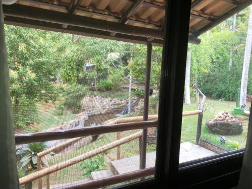 a view of a waterfall from a window at Pousada Vertente das Águas in Lumiar