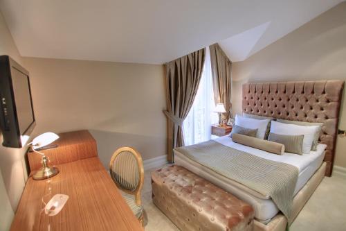 a bedroom with a large bed and a table at Lake Palace Baku in Baku