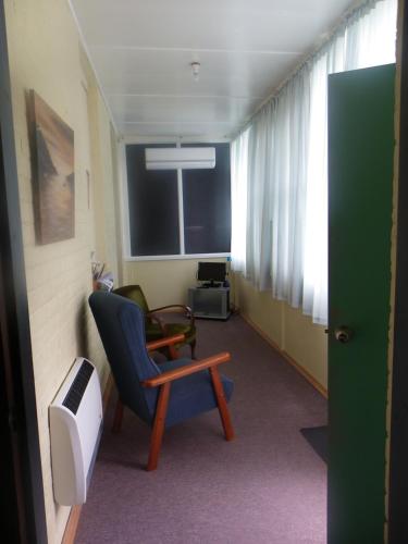 a hospital room with a chair and a window at Gallery Flat in Delegate