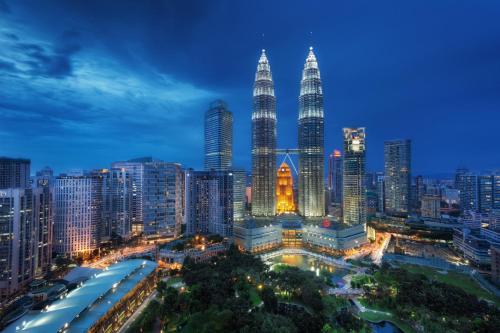 a city skyline at night with the petronas towers at Sun Inns Kelana Jaya in Petaling Jaya