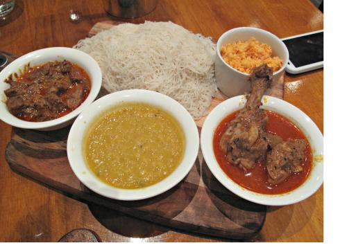 a plate of food with bowls of food and rice at Lake Infinity Luxury Condos in Nuwara Eliya