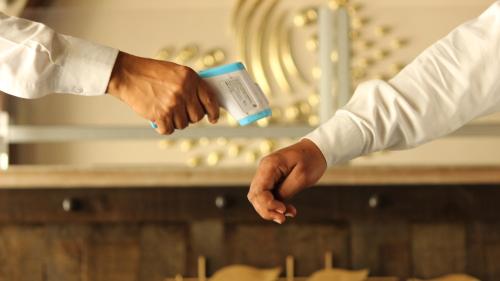 two people shaking hands in front of a table at Regenta Inn Jaipur, Adarsh Nagar in Jaipur