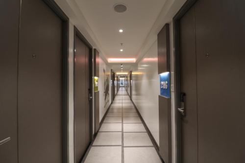 a hallway in a building with a long corridor at ZIBE Salem By GRT Hotels in Salem