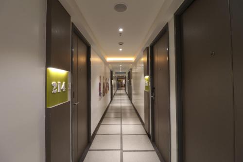a corridor of a building with a long hallway at ZIBE Salem By GRT Hotels in Salem